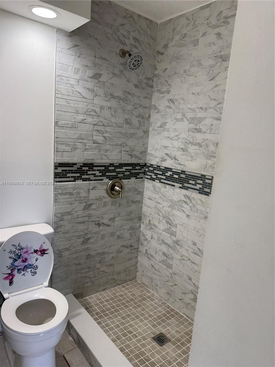 4825 Southwest 149th Court, Unit 18B Miami, FL 33185 - Photo 26 of 36 a bathroom with a toilet and a shower