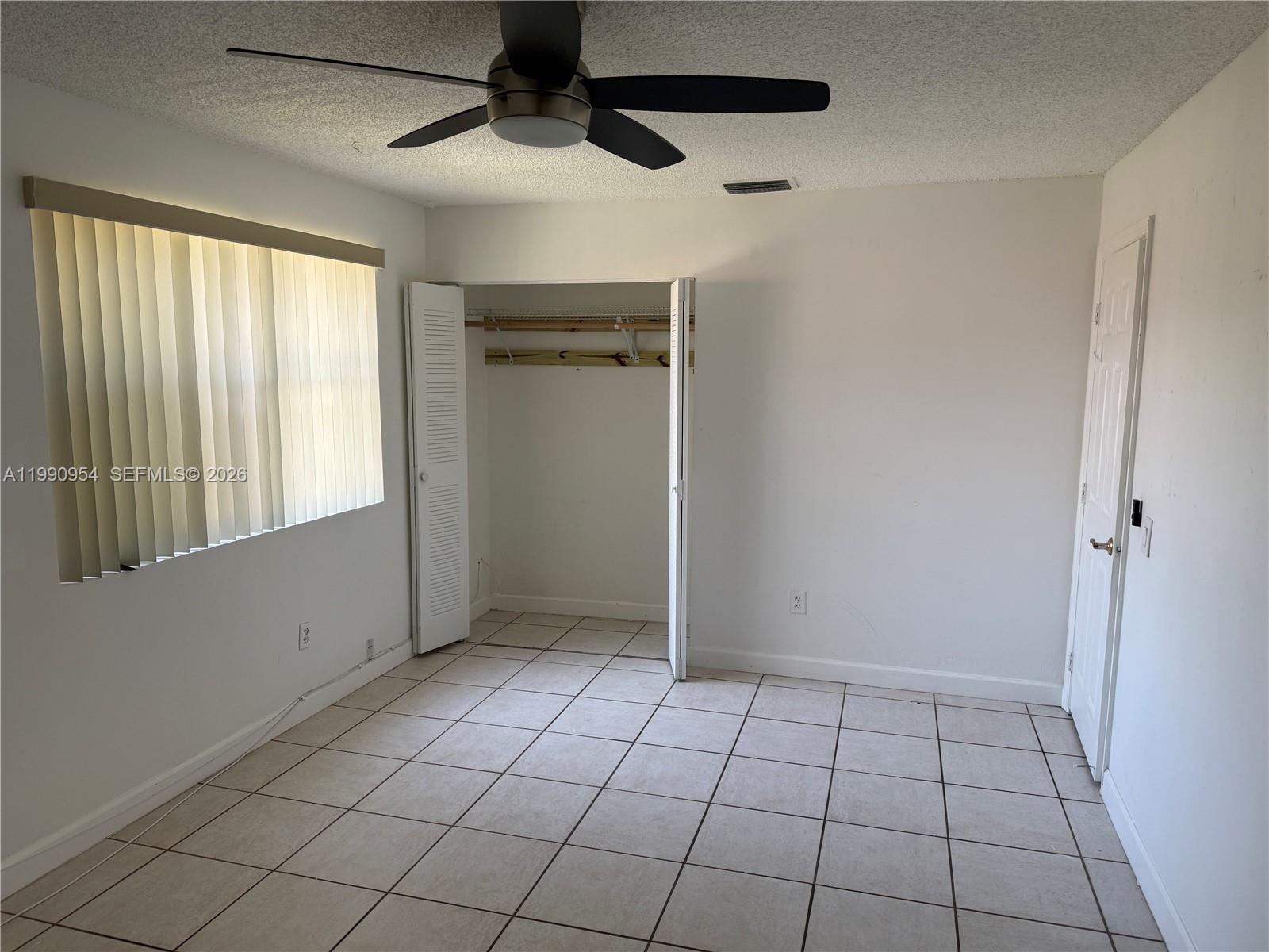 4825 Southwest 149th Court, Unit 18B Miami, FL 33185 - Photo 27 of 36 a view of an empty room and window
