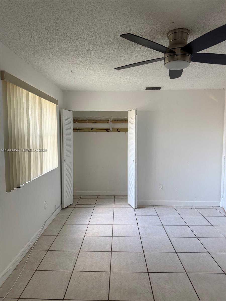 4825 Southwest 149th Court, Unit 18B Miami, FL 33185 - Photo 28 of 36 a view of a livingroom with an empty space and a window