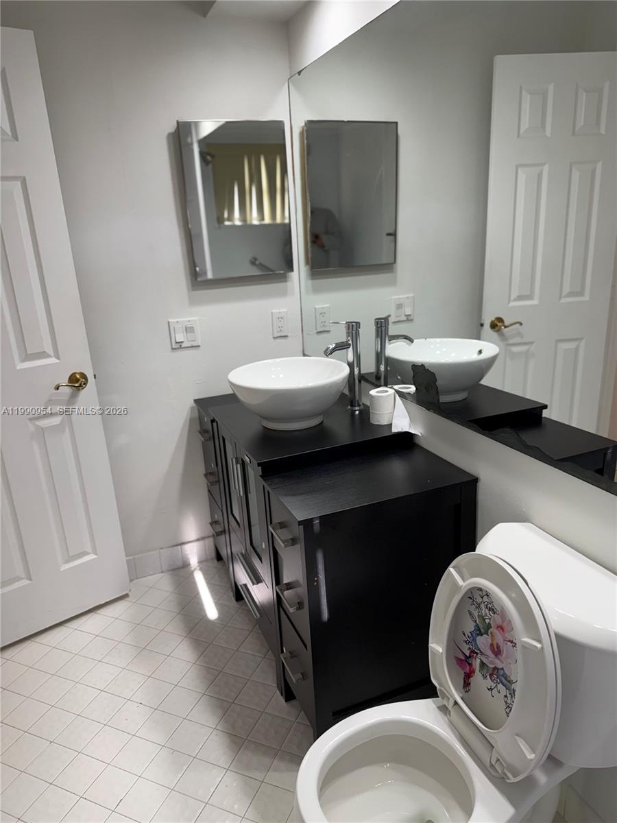 4825 Southwest 149th Court, Unit 18B Miami, FL 33185 - Photo 30 of 36 a bathroom with a sink toilet and mirror