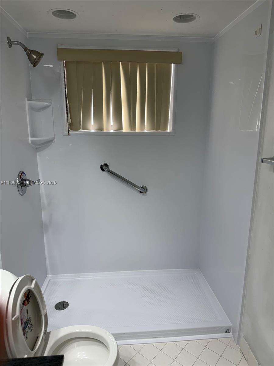4825 Southwest 149th Court, Unit 18B Miami, FL 33185 - Photo 31 of 36 a bathroom with a granite countertop sink a toilet and bathtub