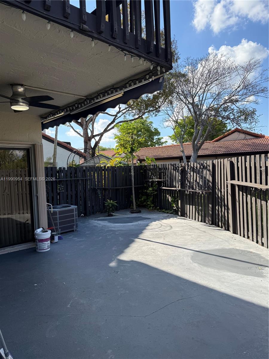 4825 Southwest 149th Court, Unit 18B Miami, FL 33185 - Photo 32 of 36 a view of a patio with table and chairs with wooden fence