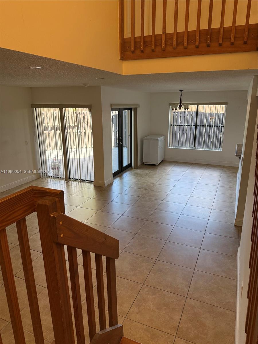 4825 Southwest 149th Court, Unit 18B Miami, FL 33185 - Photo 5 of 36 a view of an empty room with glass door