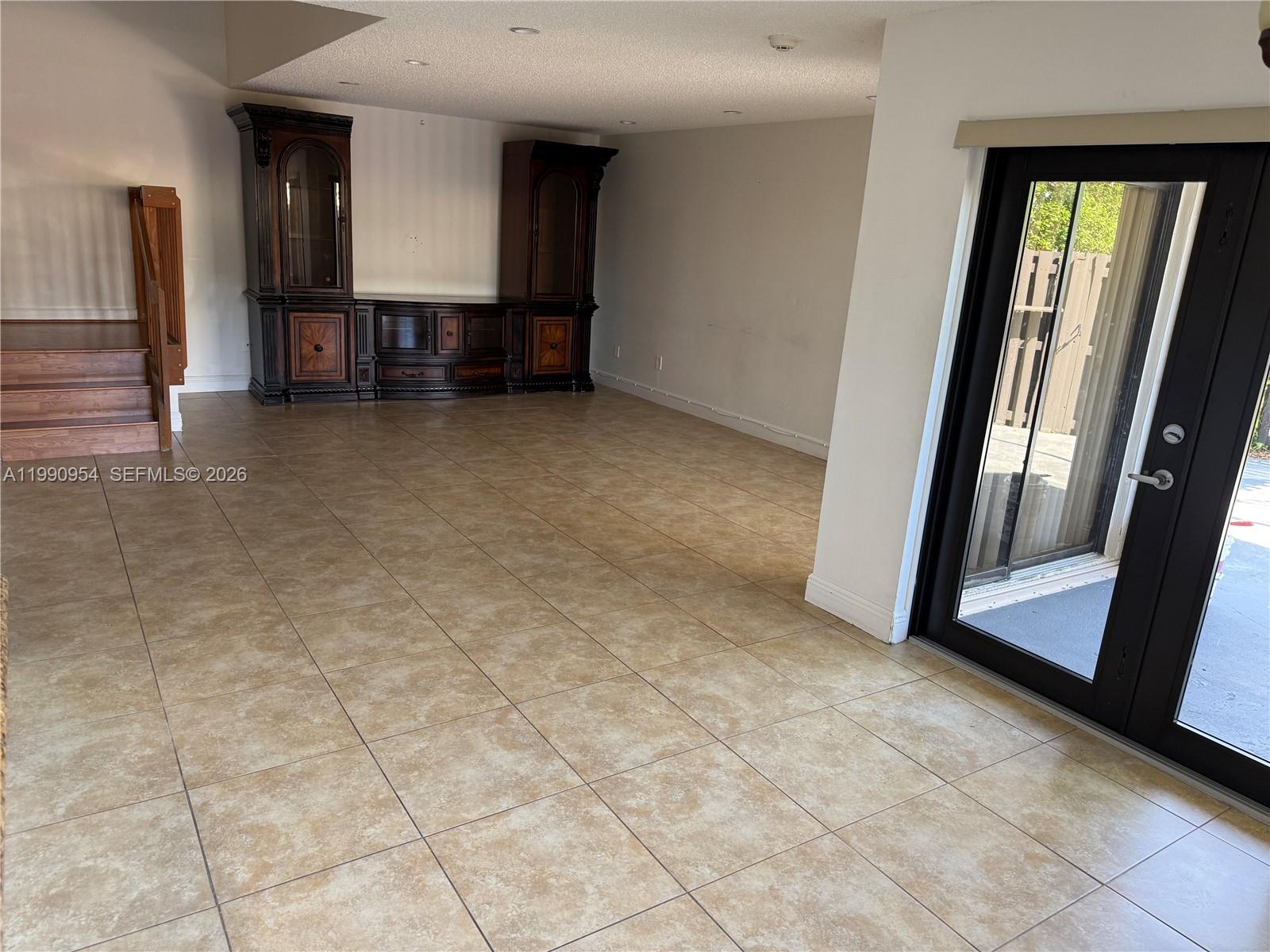 4825 Southwest 149th Court, Unit 18B Miami, FL 33185 - Photo 6 of 36 a view of empty room with a fireplace and windows