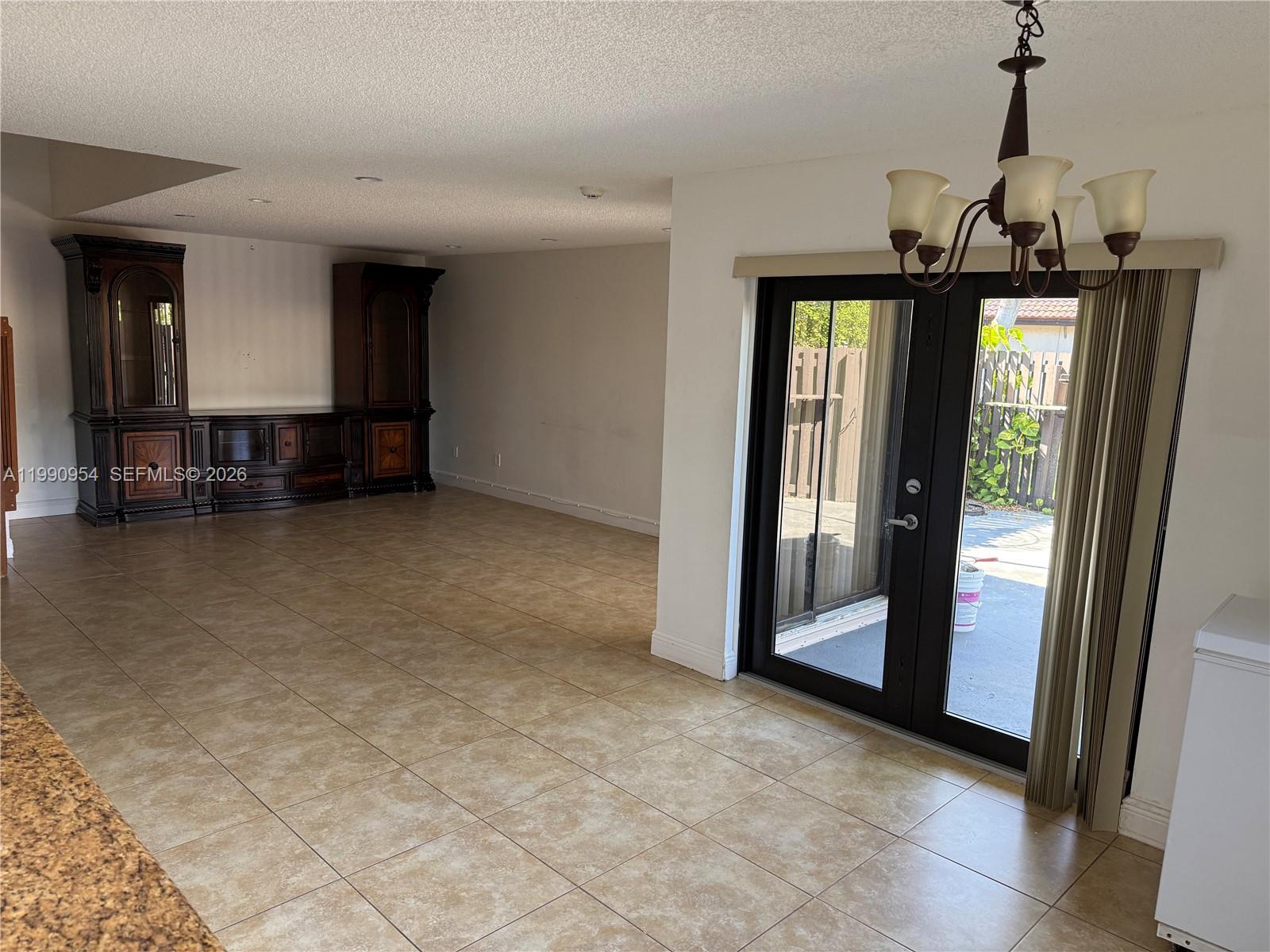 4825 Southwest 149th Court, Unit 18B Miami, FL 33185 - Photo 9 of 36 a view of a hallway with entryway and chandelier
