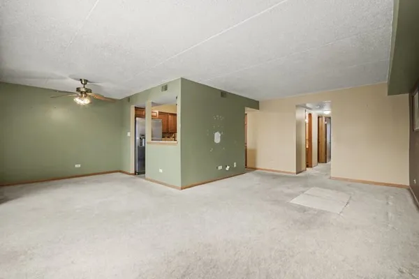 an empty room with closet and windows