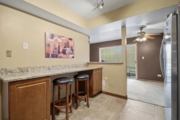 a kitchen with granite countertop a sink stainless steel appliances and cabinets