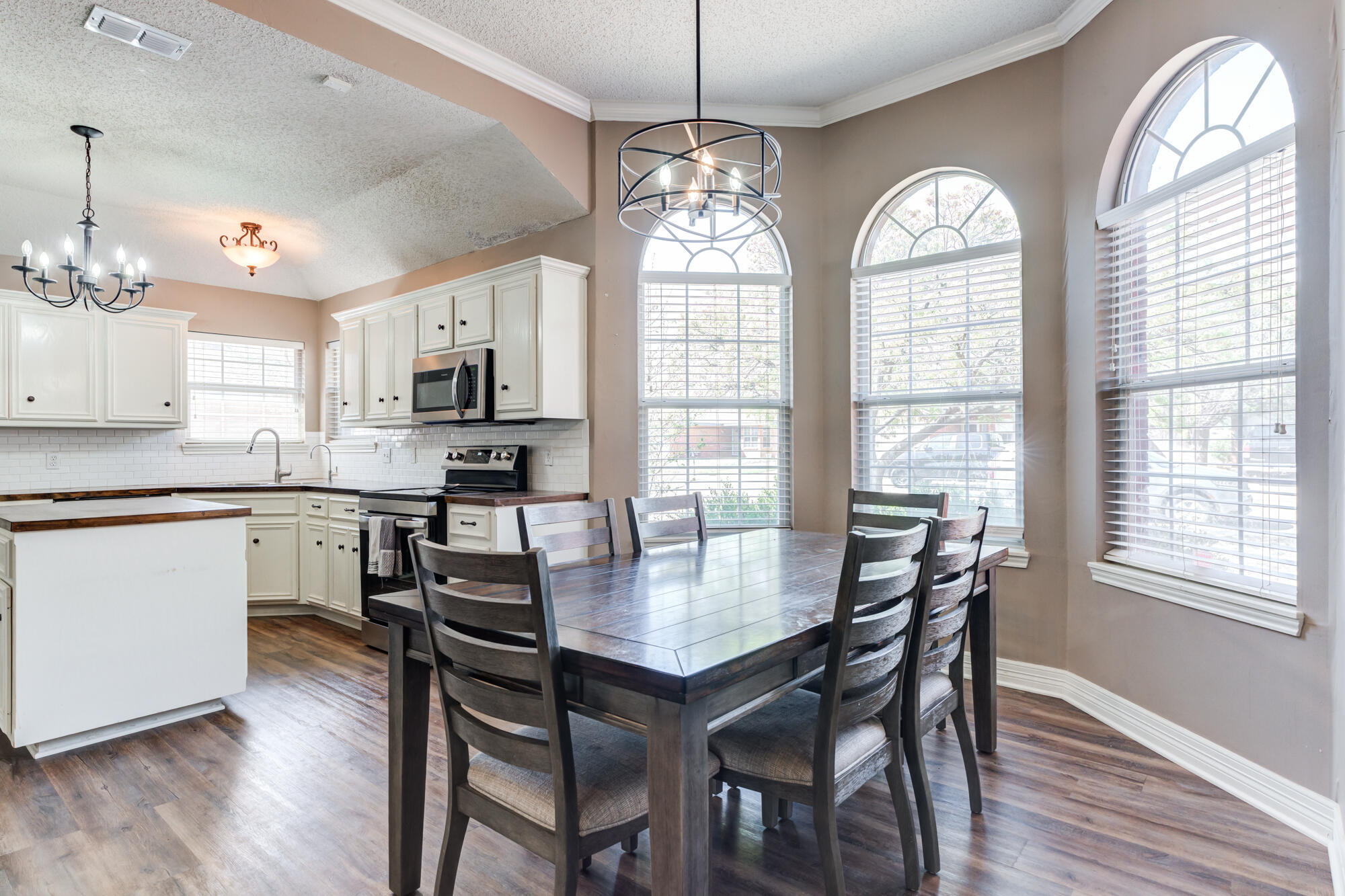 2807 87th Street Lubbock, TX 79423 - Photo 11 of 38 a view of a dining room with furniture window and wooden floor
