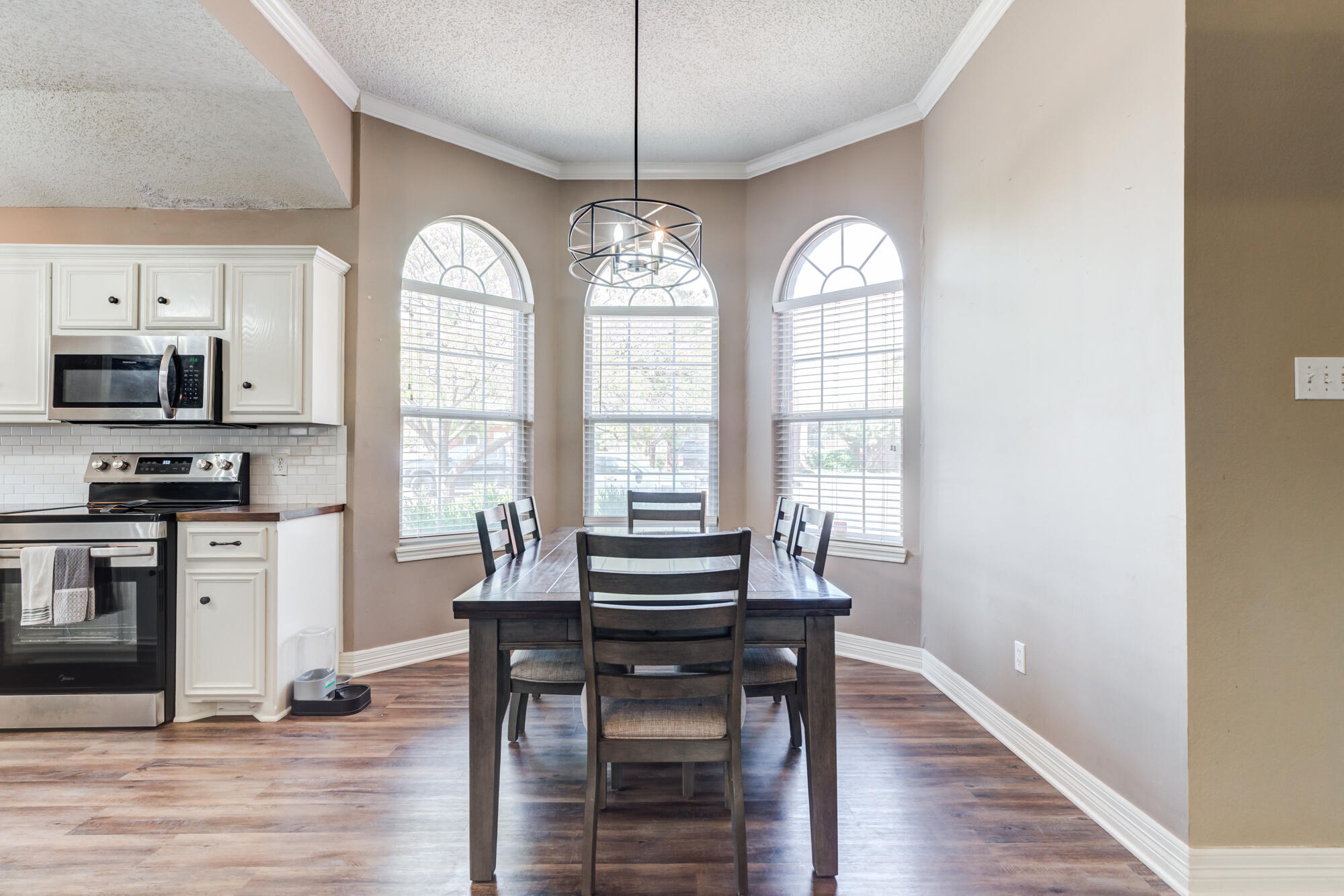 2807 87th Street Lubbock, TX 79423 - Photo 12 of 38 a view of a dining room with furniture window and wooden floor