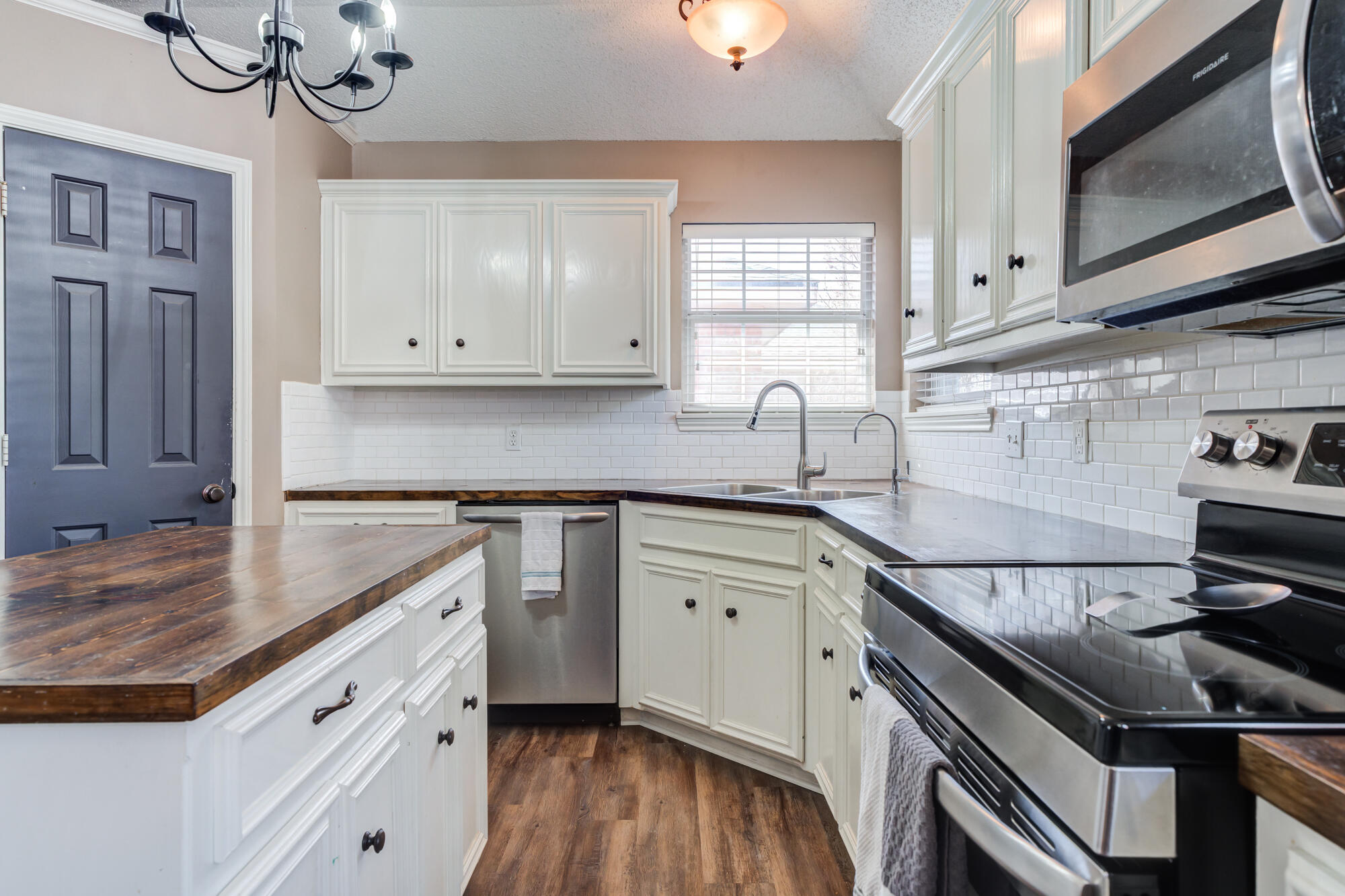 2807 87th Street Lubbock, TX 79423 - Photo 15 of 38 a kitchen with granite countertop a sink stainless steel appliances and cabinets