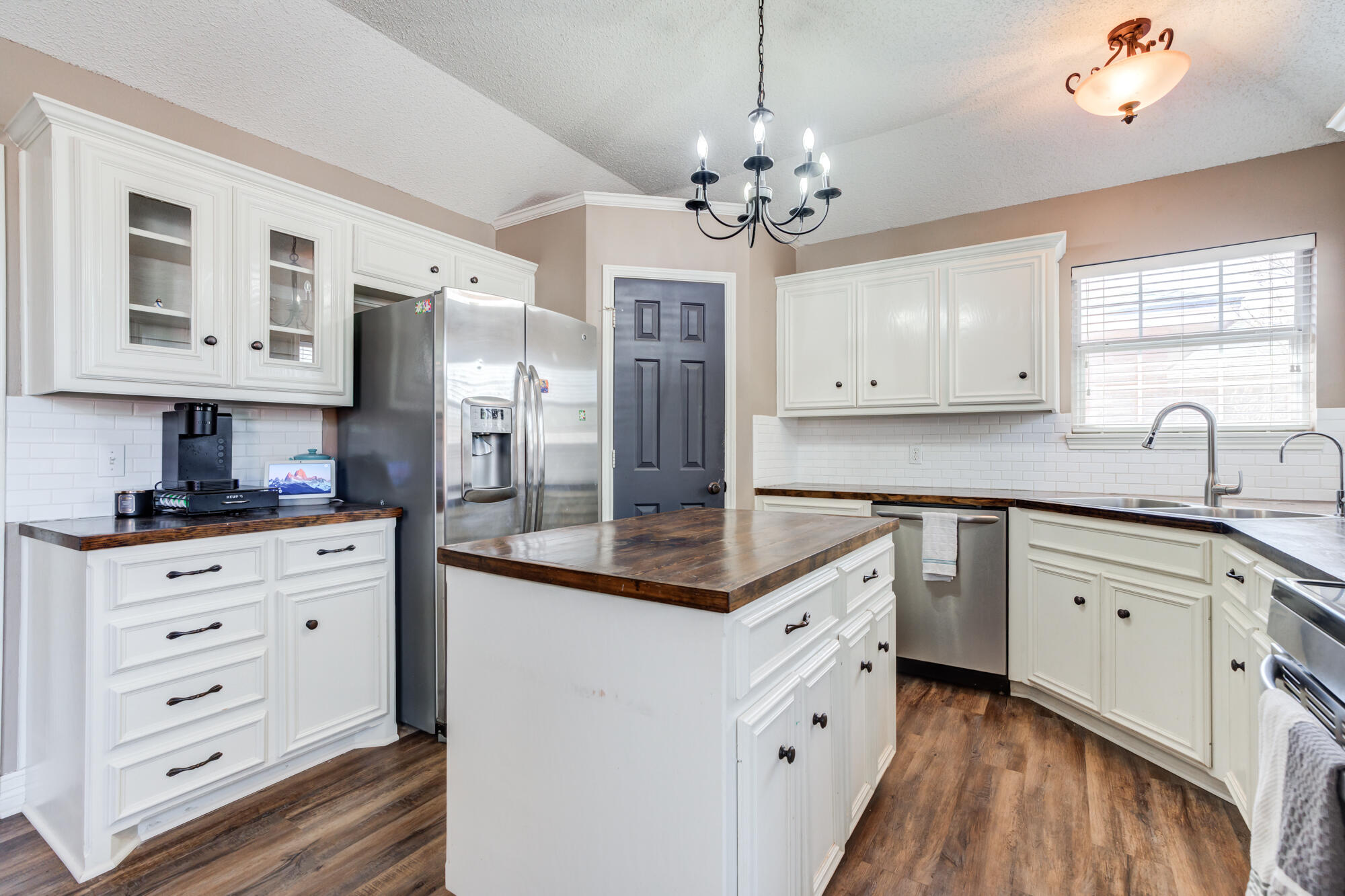 2807 87th Street Lubbock, TX 79423 - Photo 17 of 38 a kitchen with stainless steel appliances granite countertop a stove oven and white cabinets