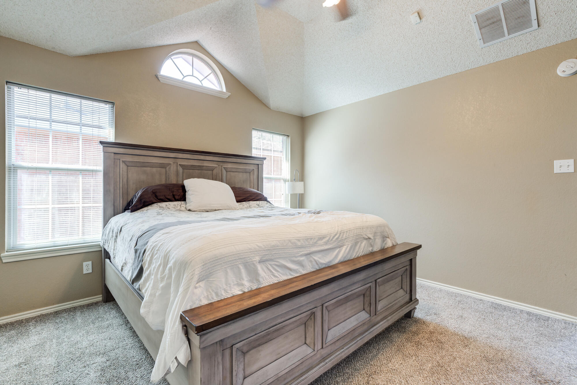 2807 87th Street Lubbock, TX 79423 - Photo 22 of 38 a bed sitting in a bedroom next to a window