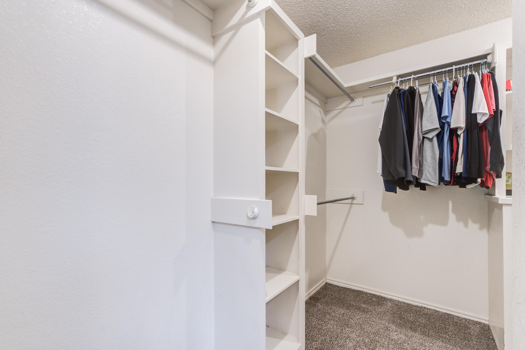 2807 87th Street Lubbock, TX 79423 - Photo 26 of 38 a view of walk in closet with clothes