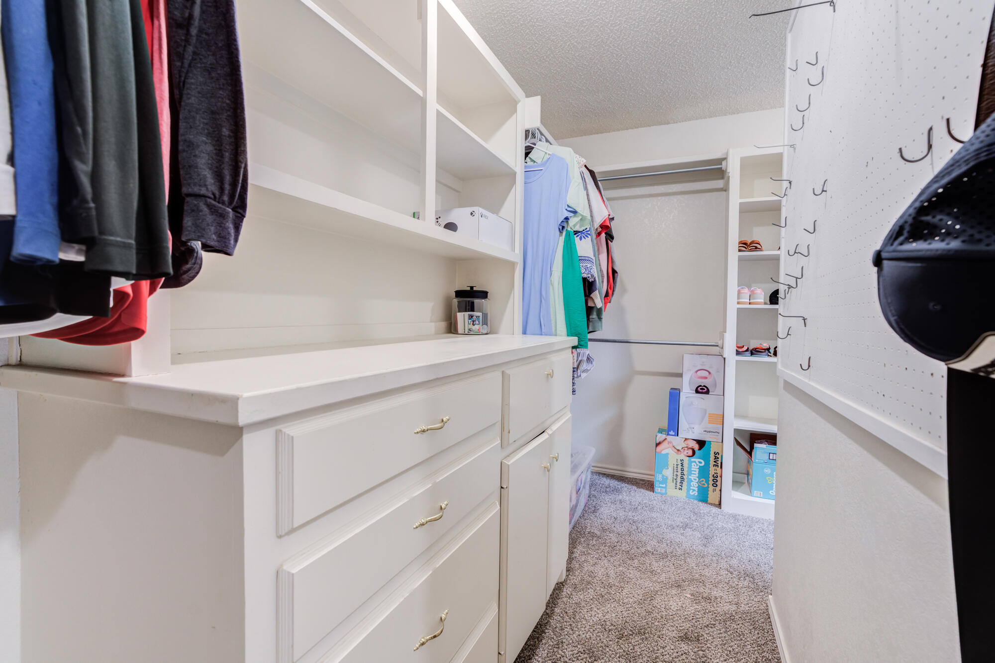 2807 87th Street Lubbock, TX 79423 - Photo 27 of 38 a view of walk in closet with clothes and shoes