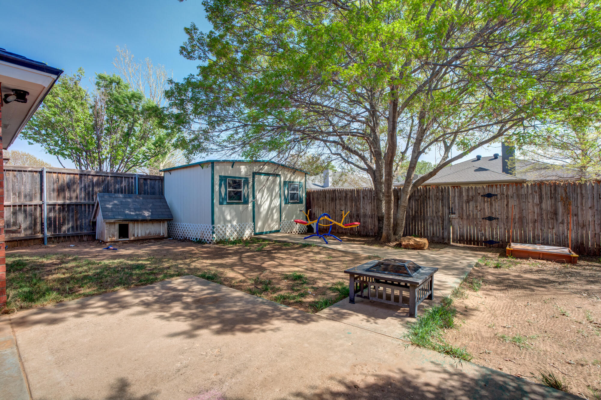 2807 87th Street Lubbock, TX 79423 - Photo 36 of 38 a wooden bench sitting in front of a house