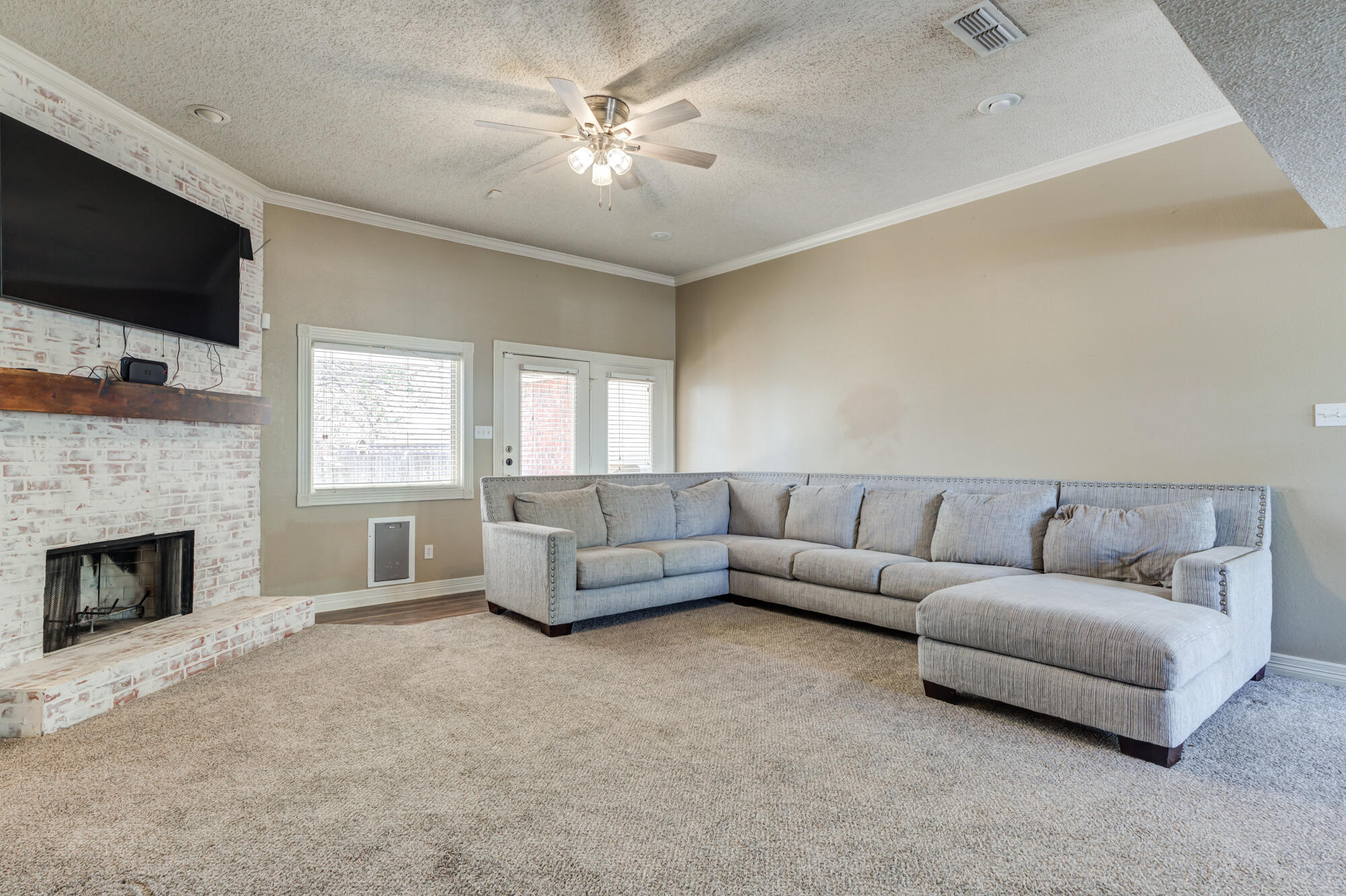 2807 87th Street Lubbock, TX 79423 - Photo 6 of 38 a living room with furniture fireplace and flat screen tv