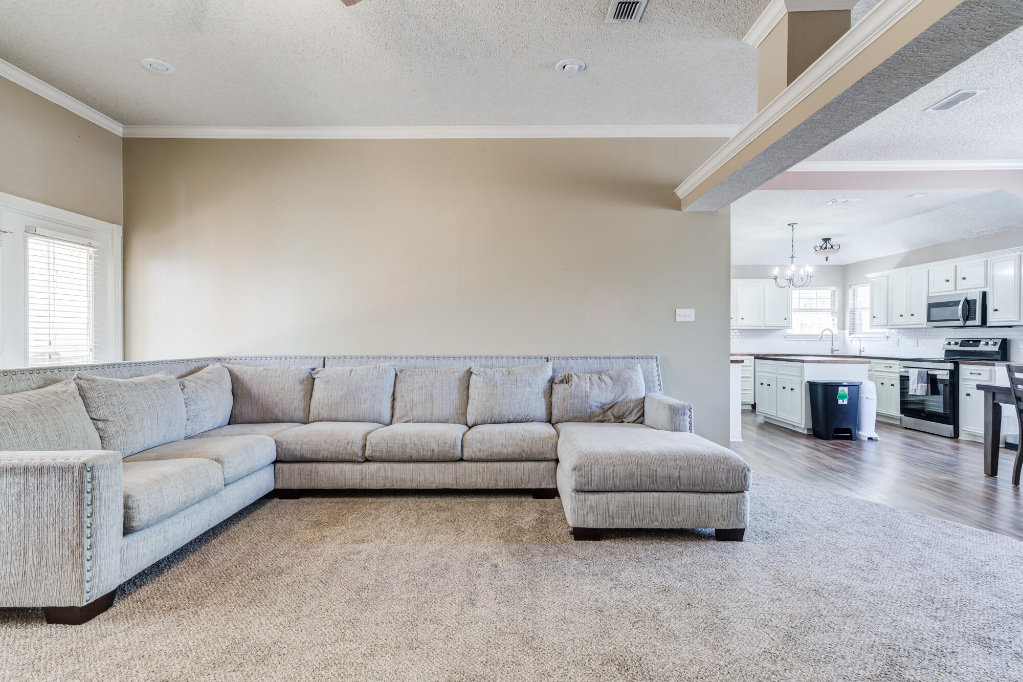 2807 87th Street Lubbock, TX 79423 - Photo 7 of 38 a living room with furniture and kitchen view