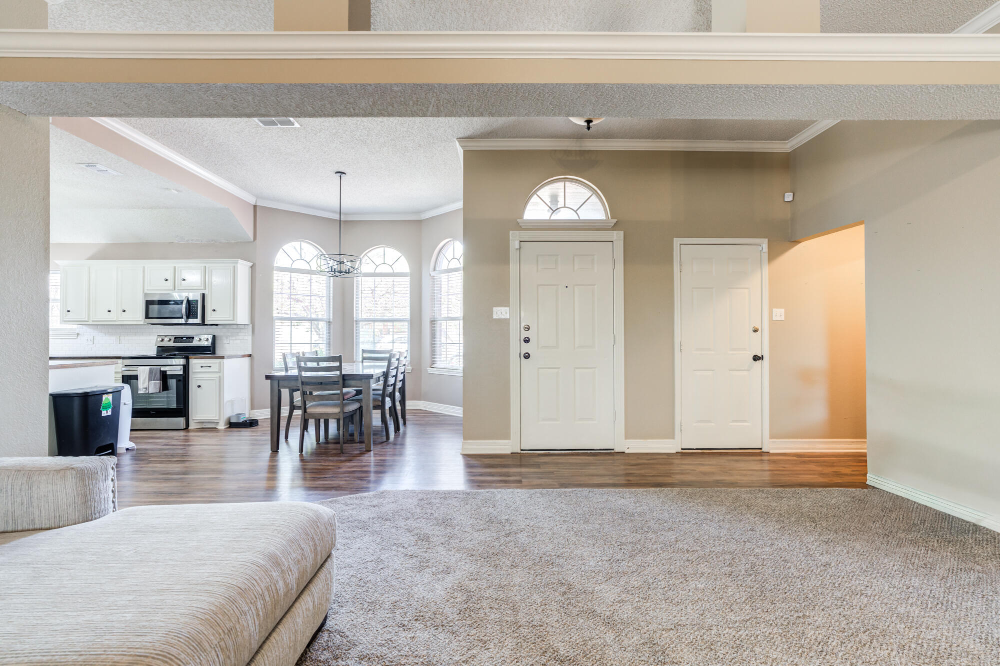 2807 87th Street Lubbock, TX 79423 - Photo 9 of 38 a view of a livingroom with furniture and a chandelier