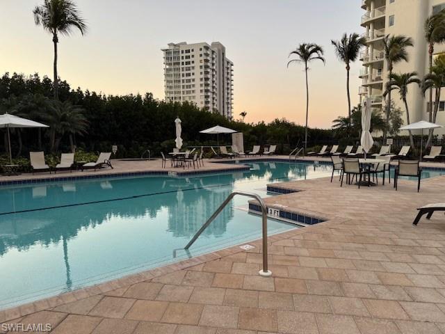 20 Seagate Drive, Unit 703 Naples, FL 34103 - Photo 15 of 19 a view of swimming pool outdoor seating and city view