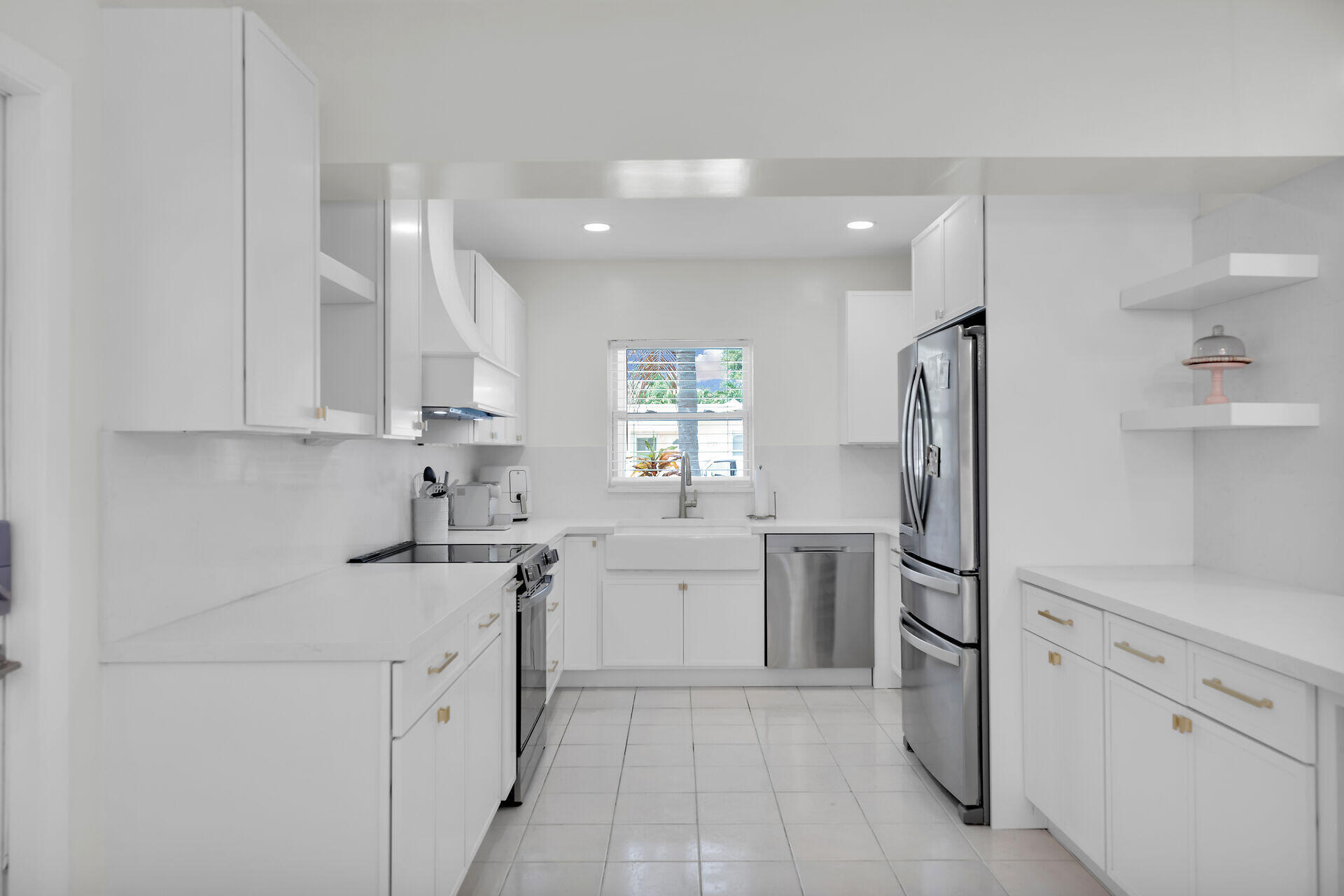3722 Cindy Avenue Key West, FL 33040 - Photo 11 of 38 a kitchen with white cabinets and stainless steel appliances
