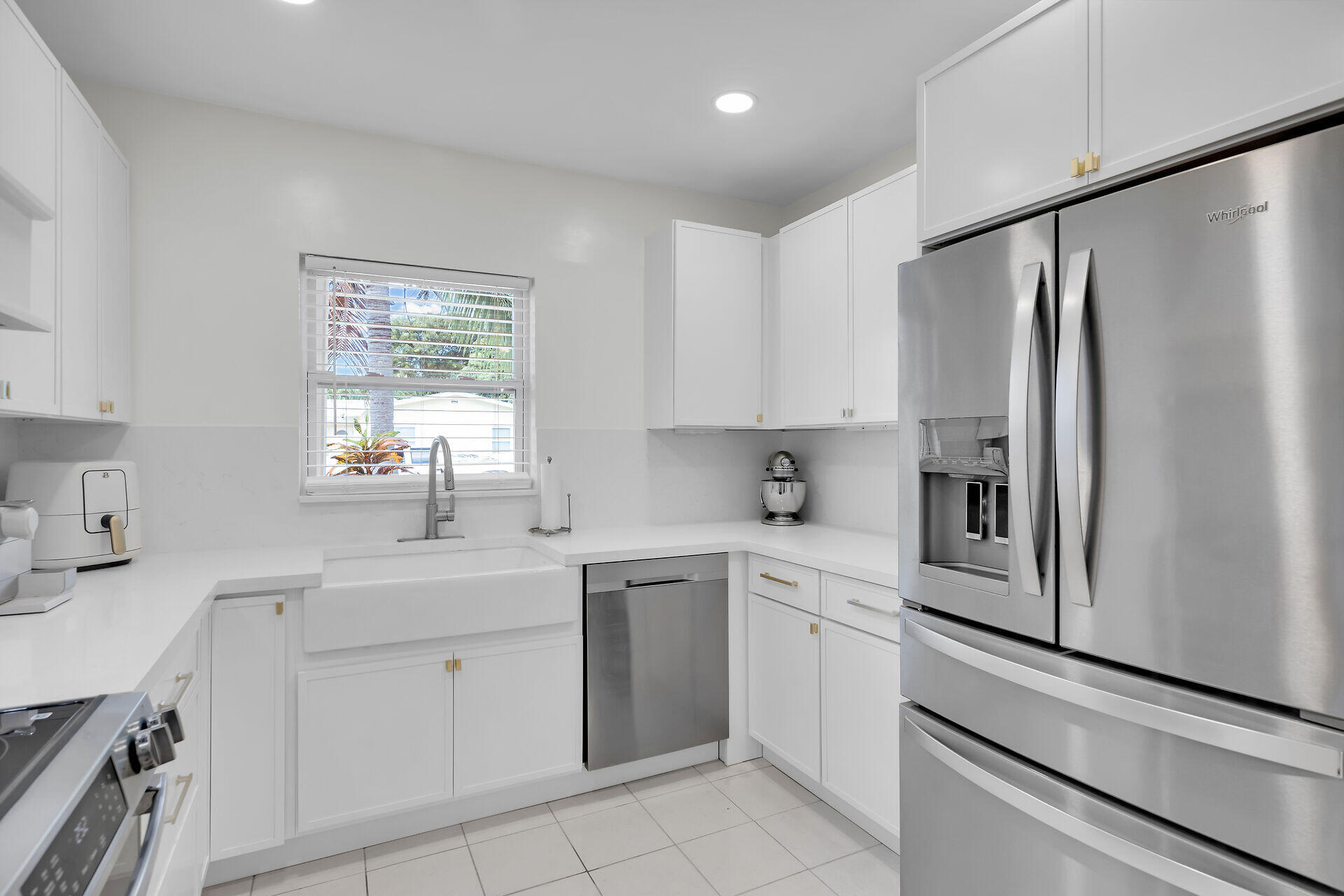 3722 Cindy Avenue Key West, FL 33040 - Photo 14 of 38 a kitchen with white cabinets and white appliances