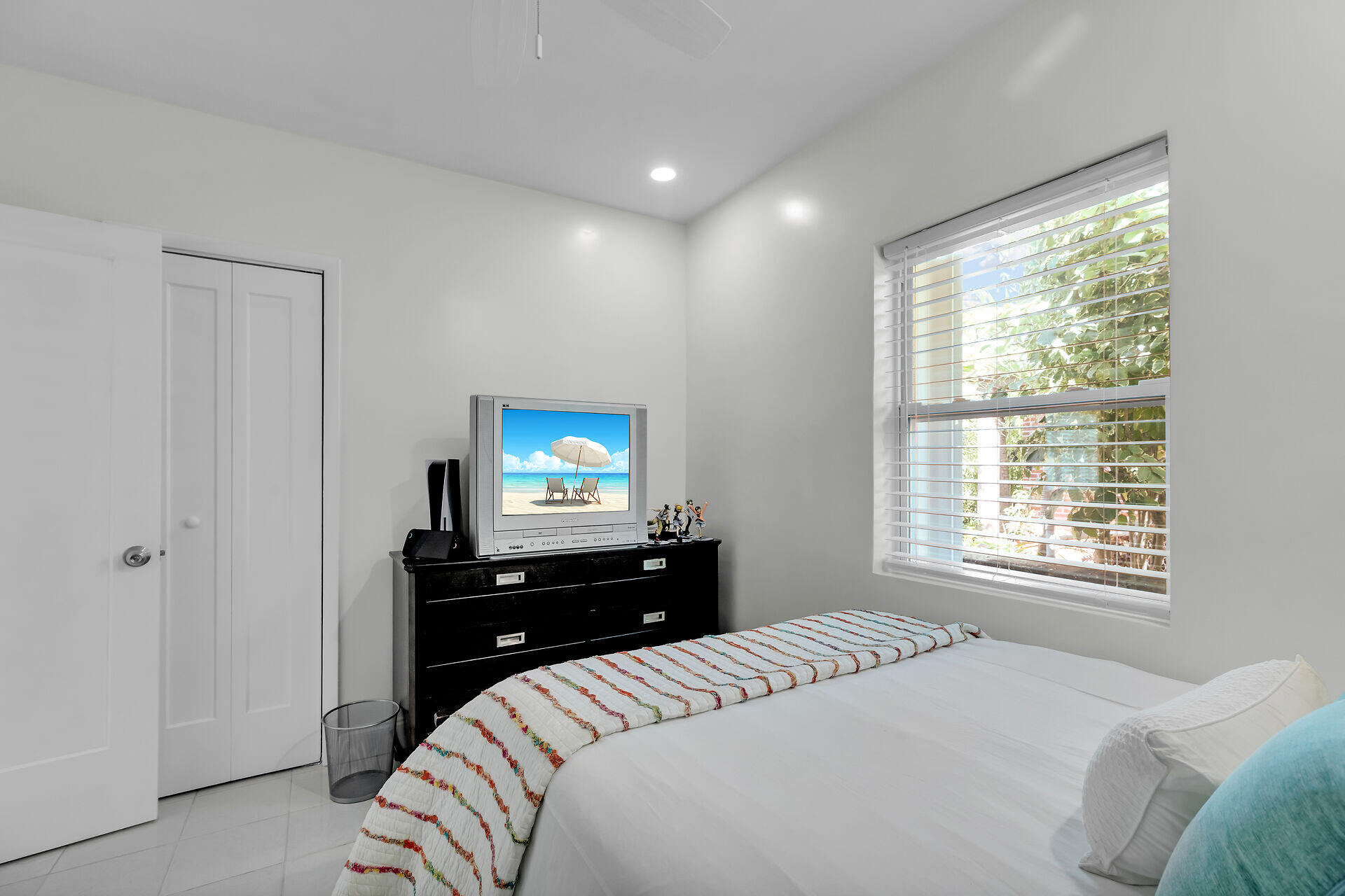 3722 Cindy Avenue Key West, FL 33040 - Photo 30 of 38 a bedroom with a bed and a flat tv screen on a dresser