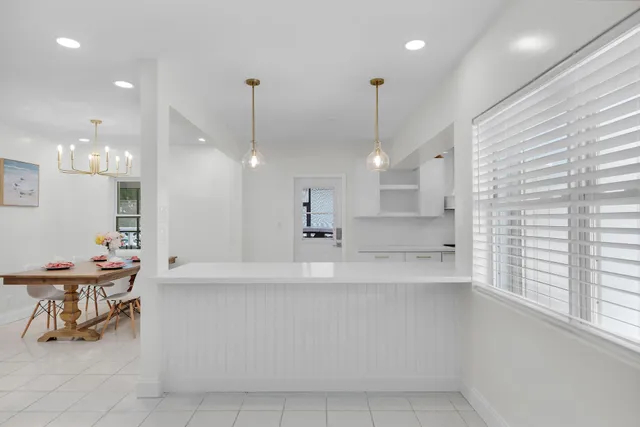 a large kitchen with a table and chairs