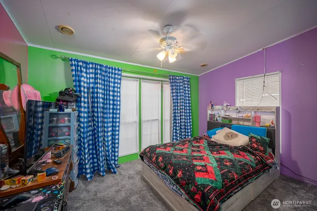 a bedroom with a bed and flat screen tv