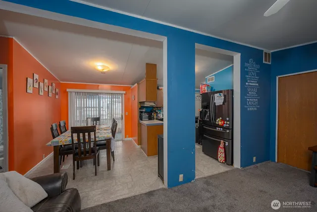 a kitchen with kitchen island granite countertop a stove top oven a sink dishwasher and a microwave with wooden cabinets