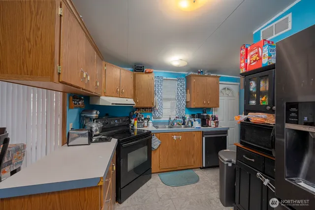 a kitchen with a stove and a refrigerator