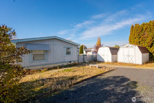 a view of a house with a yard and garage