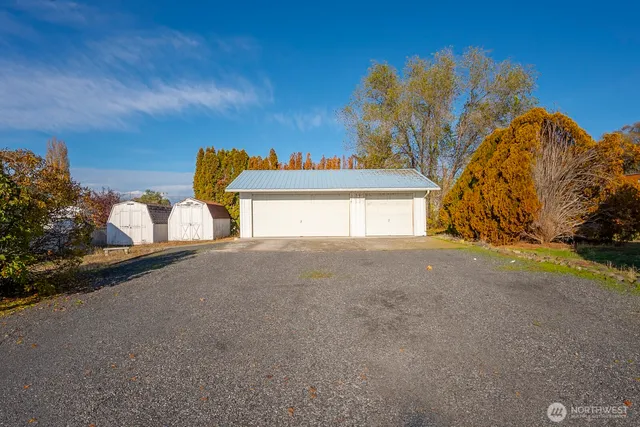 a front view of a house with a yard and potted plants