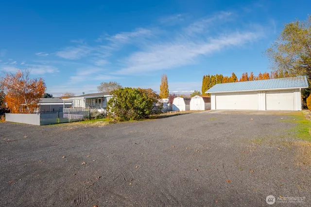 an aerial view of a residential houses with outdoor space
