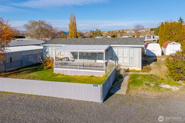 a view of a house with pool and chairs