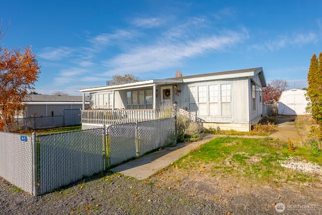 a view of a house with backyard and balcony