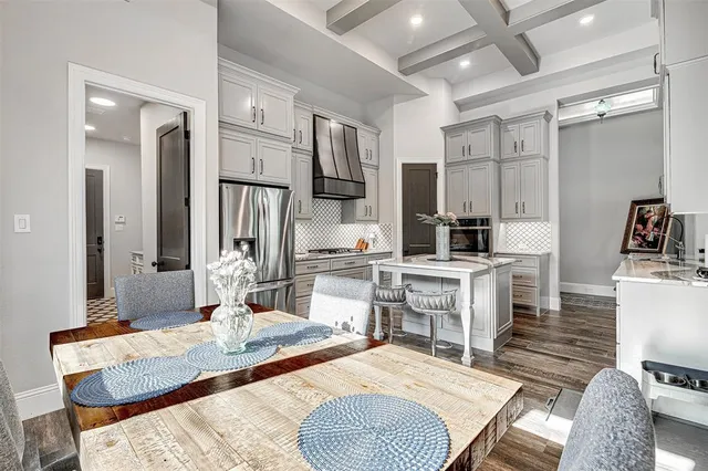 a large kitchen with sink refrigerator and cabinets