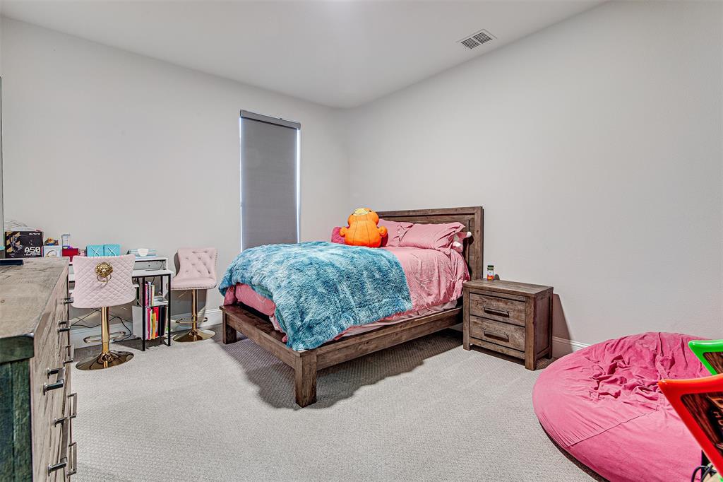 13924 East Riviera Drive Fort Worth, TX 76028 - Photo 24 of 38 a bedroom with a bed and a dresser