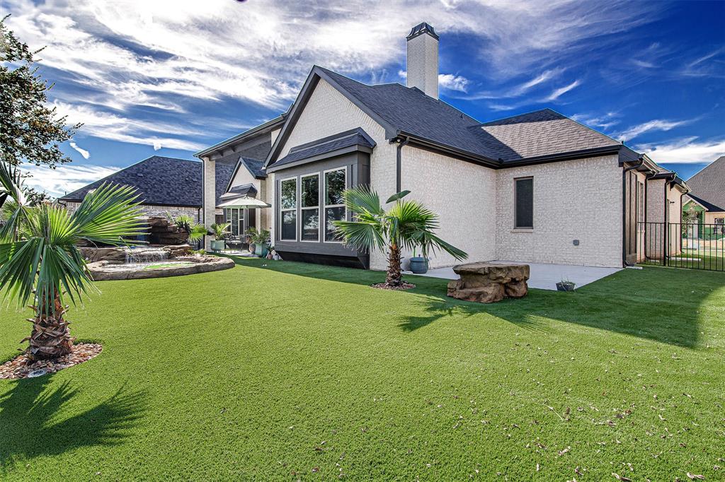 13924 East Riviera Drive Fort Worth, TX 76028 - Photo 33 of 38 a front view of a house with garden