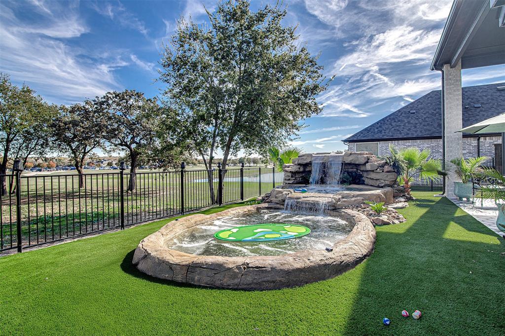 13924 East Riviera Drive Fort Worth, TX 76028 - Photo 37 of 38 a swimming pool with outdoor seating and garden