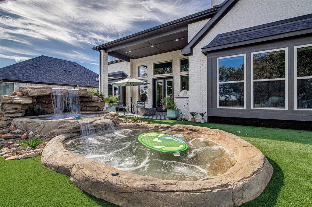 13924 East Riviera Drive Fort Worth, TX 76028 - Photo 38 of 38 a view of a house with swimming pool and a yard