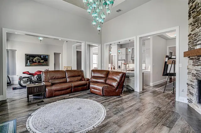 a living room with furniture and a chandelier