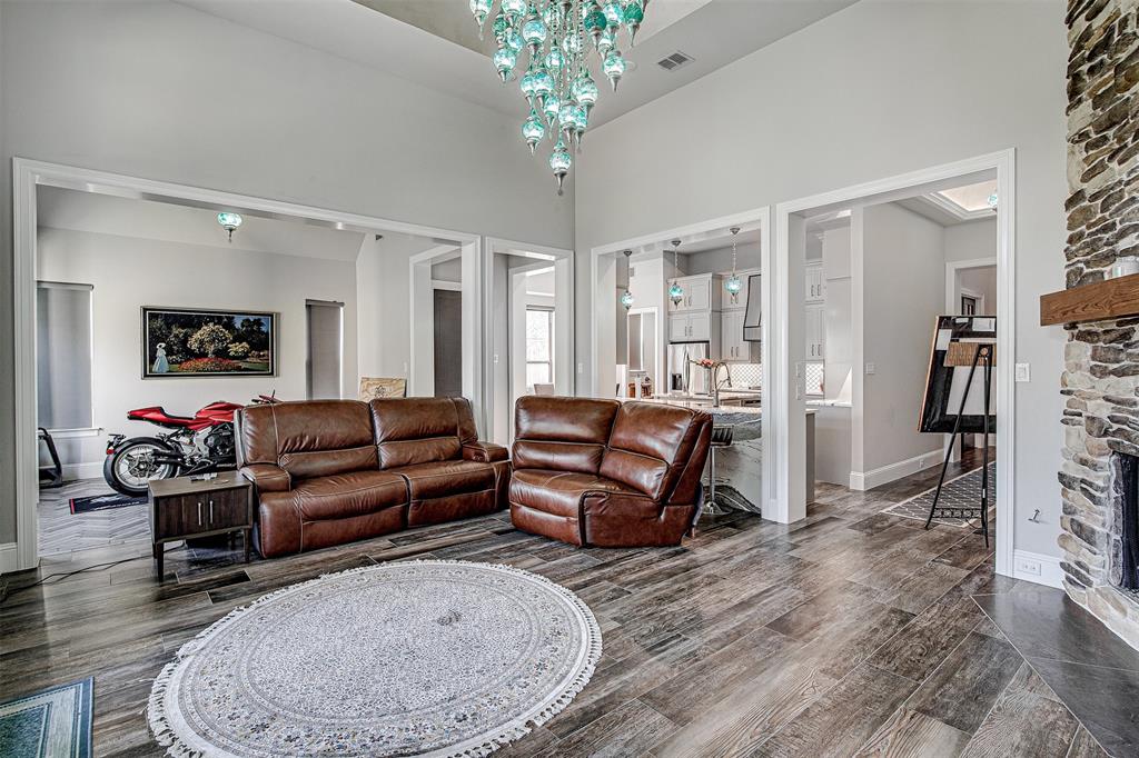 13924 East Riviera Drive Fort Worth, TX 76028 - Photo 5 of 38 a living room with furniture and a chandelier