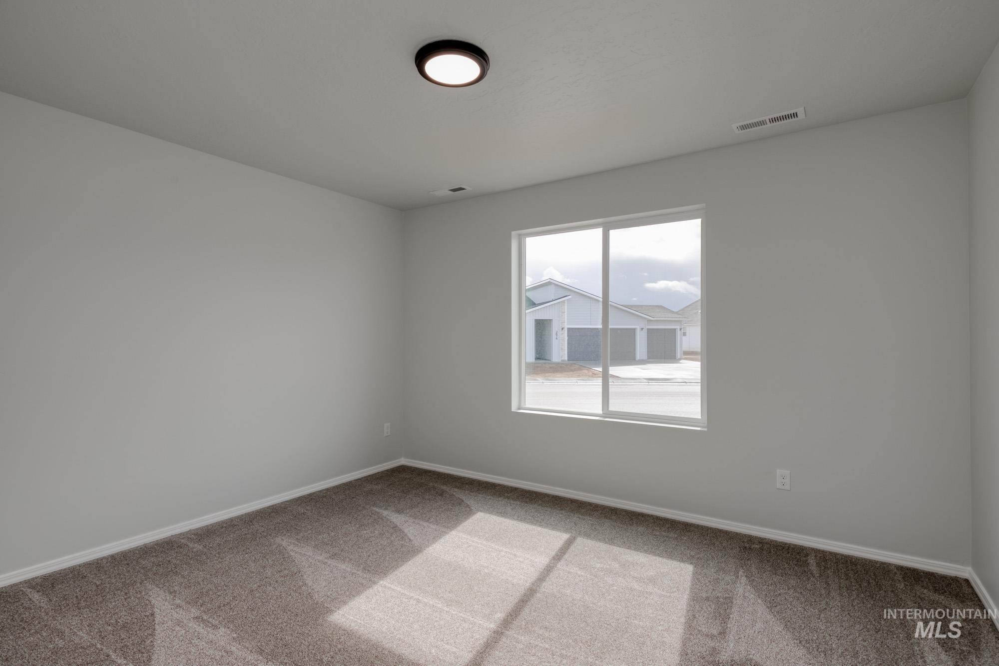 3150 South Maple Rnch Way Nampa, ID 83686 - Photo 13 of 22 Empty room featuring light carpet