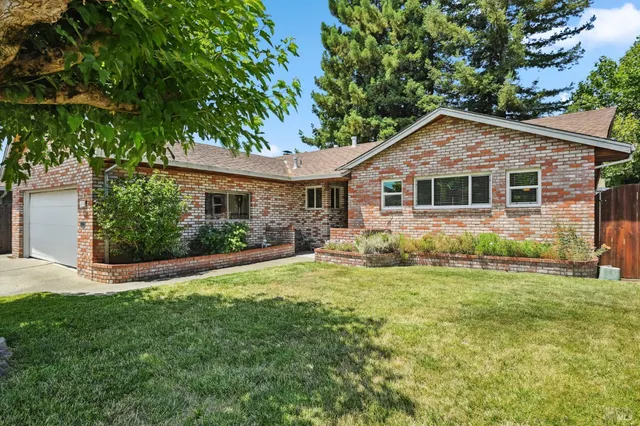 a front view of house with yard and green space