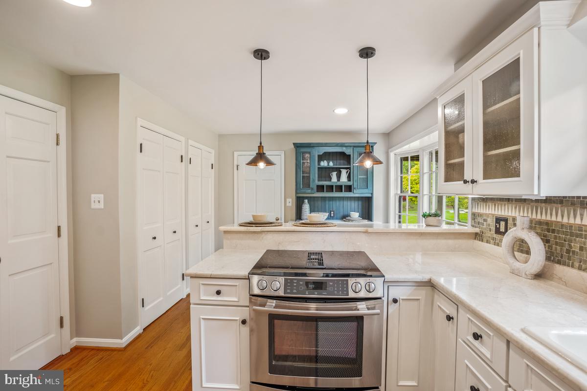121 Farmgate Lane Silver Spring, MD 20905 - Photo 16 of 51 a kitchen with stove cabinets and a wooden floor