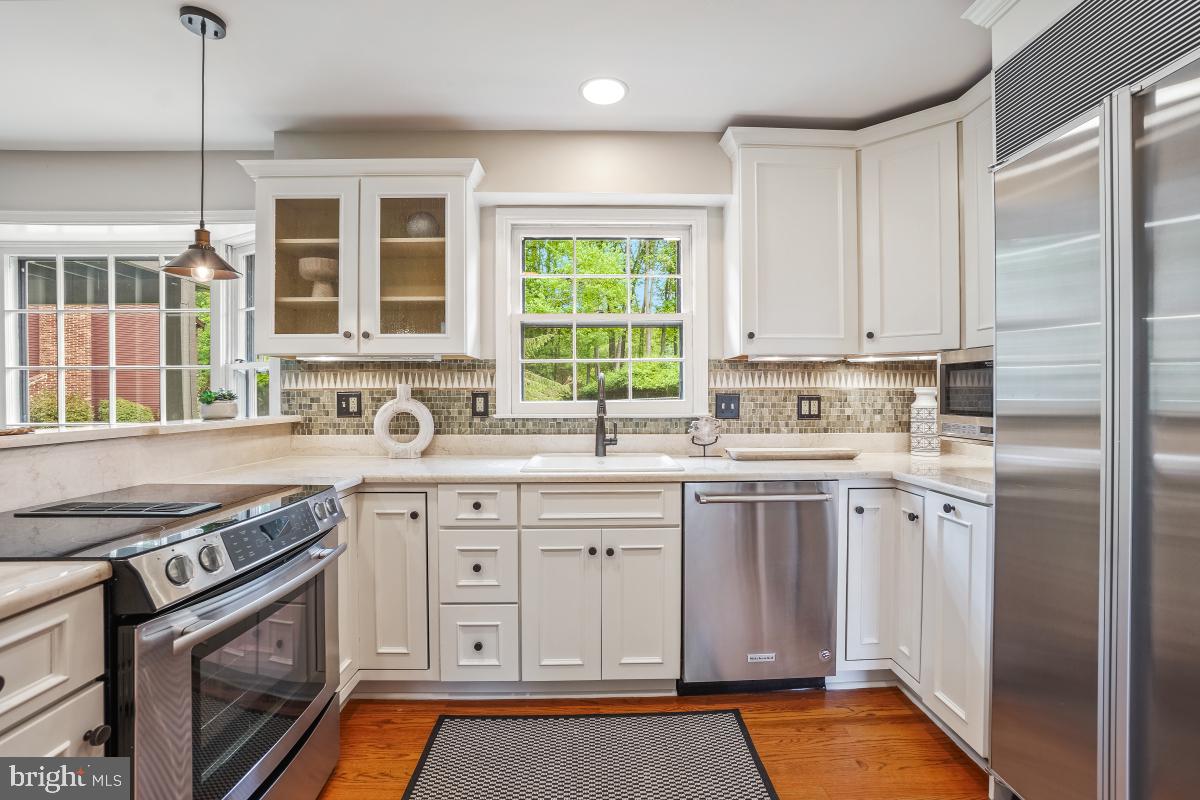 121 Farmgate Lane Silver Spring, MD 20905 - Photo 21 of 51 a kitchen with stainless steel appliances granite countertop a stove a sink and a refrigerator