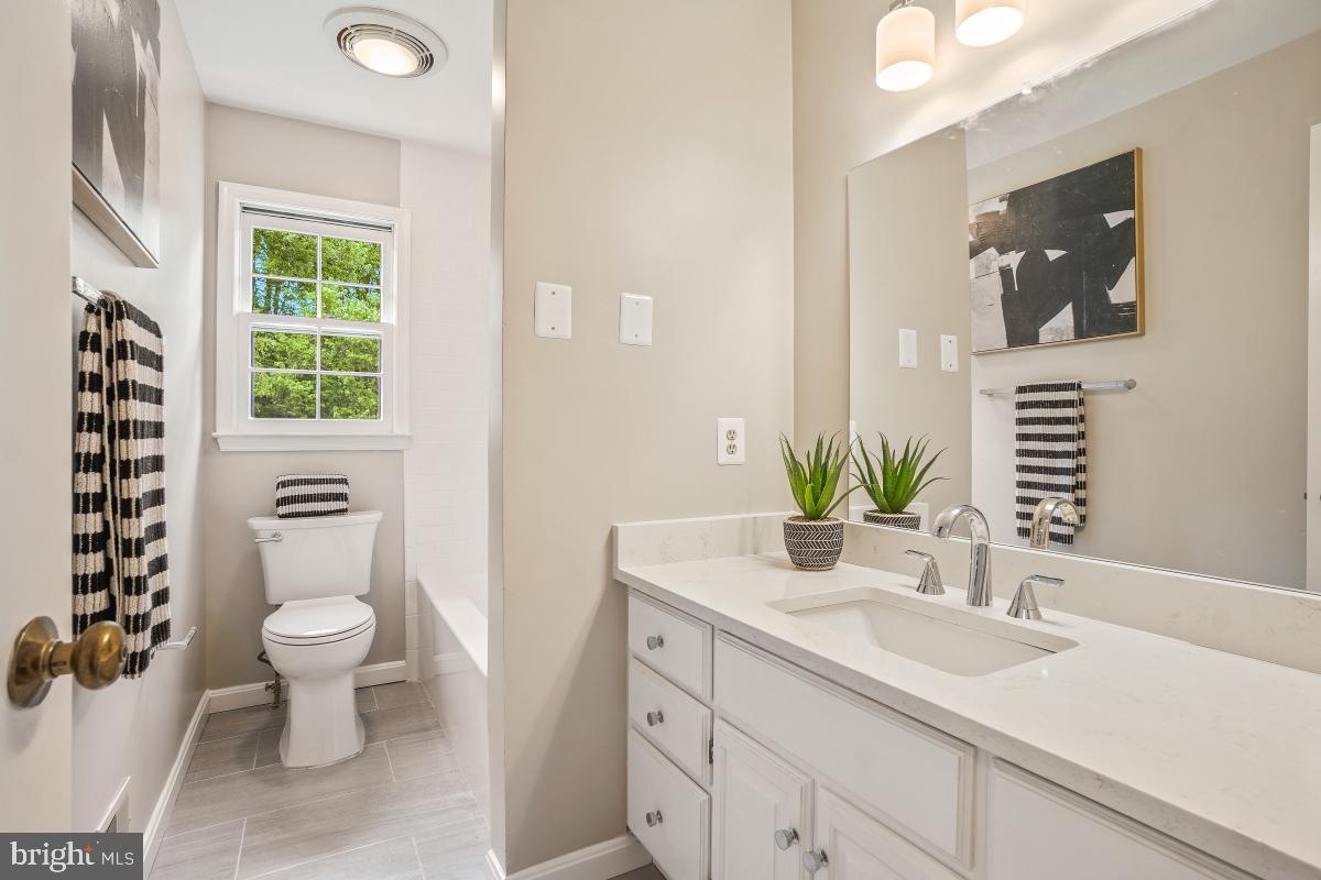 121 Farmgate Lane Silver Spring, MD 20905 - Photo 33 of 51 a bathroom with a granite countertop toilet sink and mirror