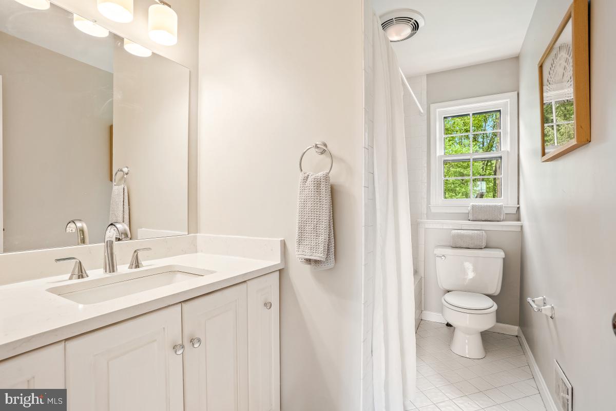 121 Farmgate Lane Silver Spring, MD 20905 - Photo 39 of 51 a bathroom with a sink a toilet and a mirror