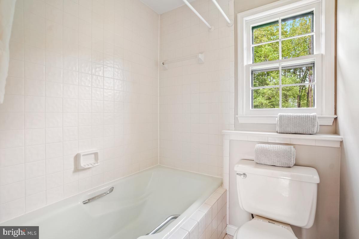 121 Farmgate Lane Silver Spring, MD 20905 - Photo 40 of 51 a bathroom with a bathtub and window
