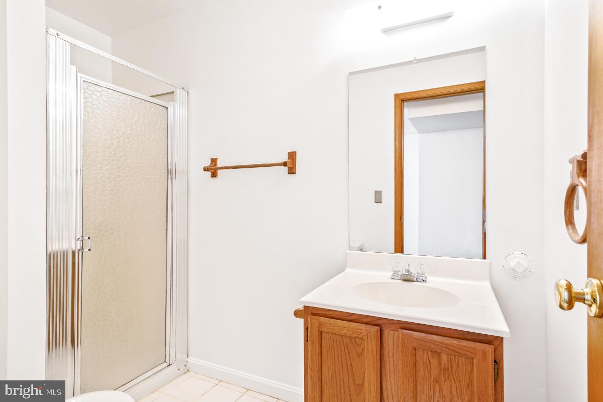 121 Farmgate Lane Silver Spring, MD 20905 - Photo 44 of 51 a bathroom with a sink and a mirror